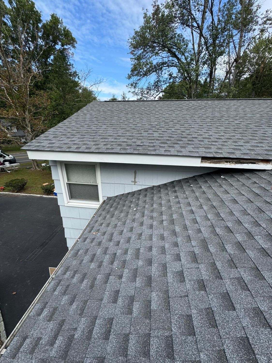 Gray architectural shingle roof on a split-level house, seen from above