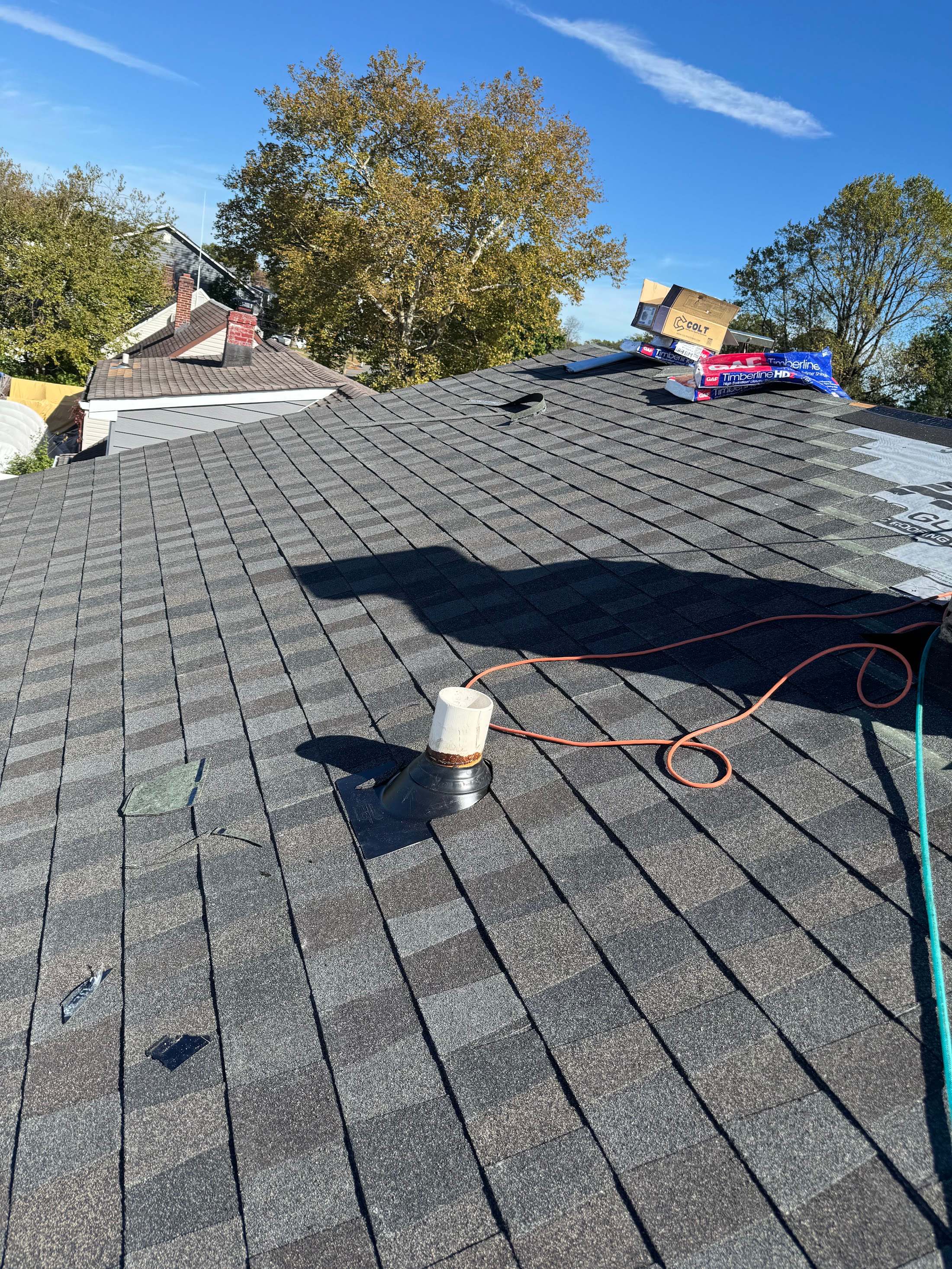 Close view of an asphalt shingle roof with a pipe vent